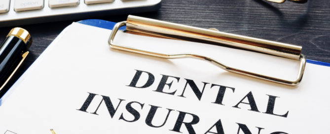 A pen and paper with the words dental insurance written on it.