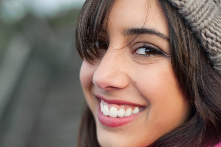 A close up of a person smiling with teeth
