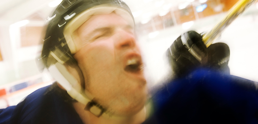 A man with a helmet on is yawning.