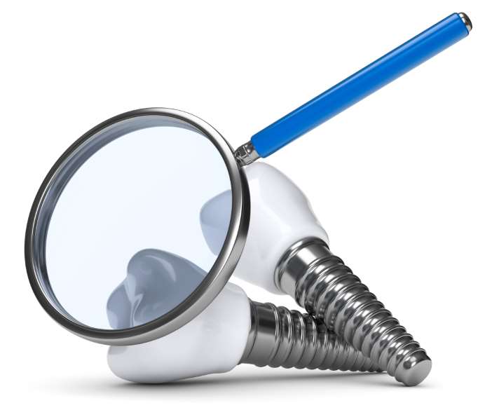 A magnifying glass is on the head of a dental implant.