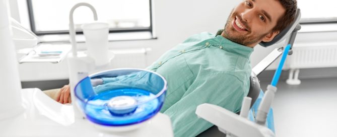 A man in dental chair smiling at the camera.