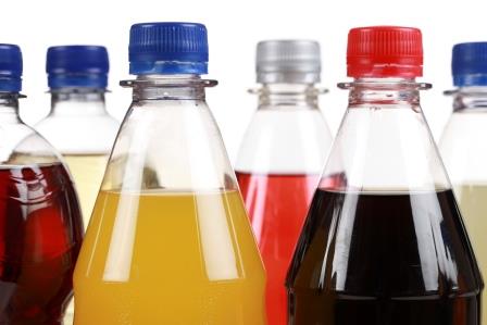 A close up of several bottles of different drinks